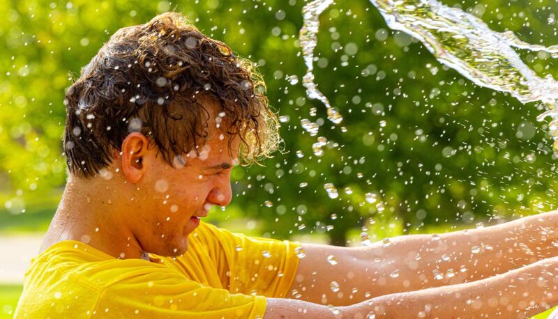 A student being splashed with water.