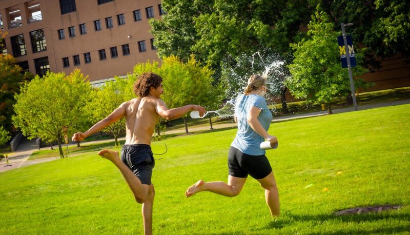 A student being splashed with water.