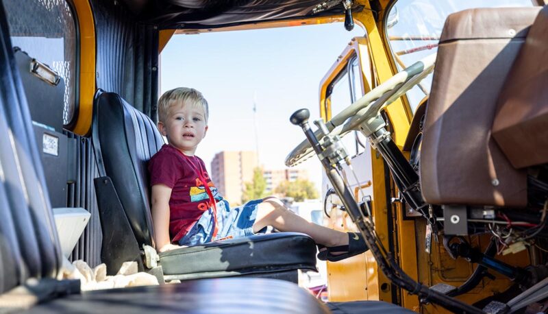 A young child in the driver's seat of a truck