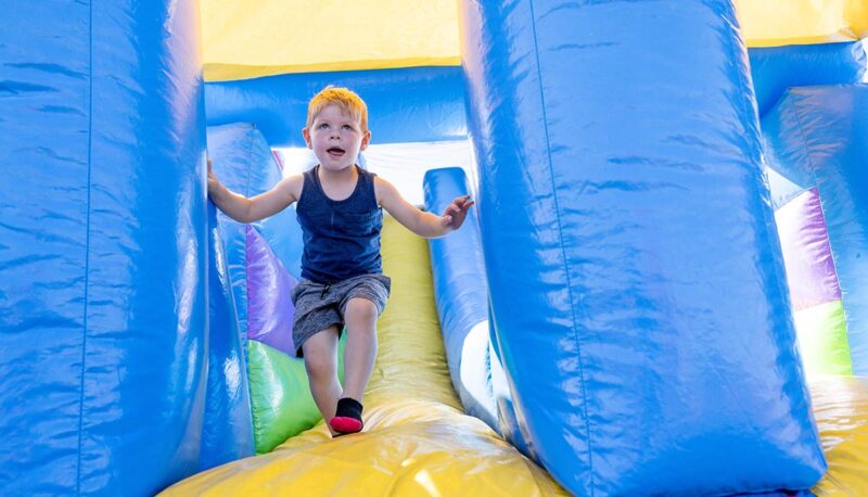 A young child in an inflatable bounce house.