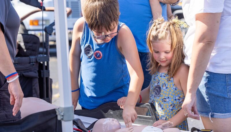 A young child with a CPR dummy