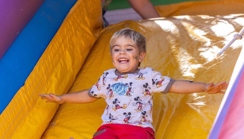 A toddler sliding down an inflatable slide