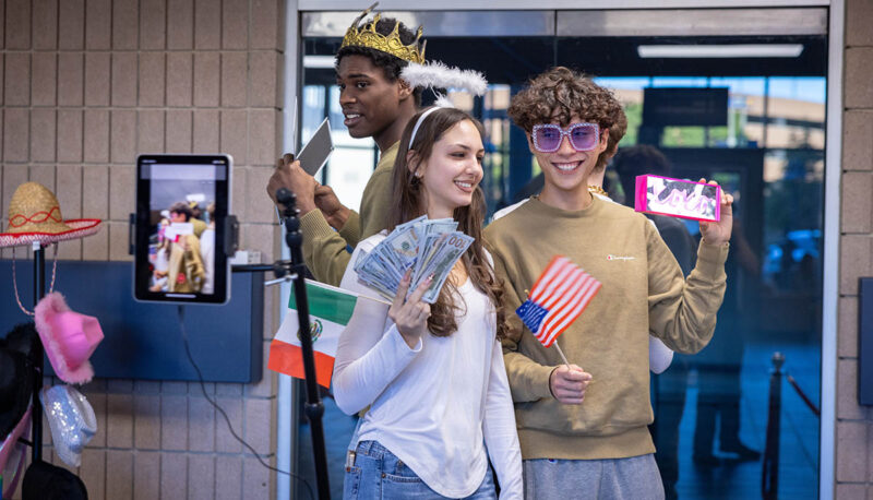 Students showing the prizes they've won during a giveaway.