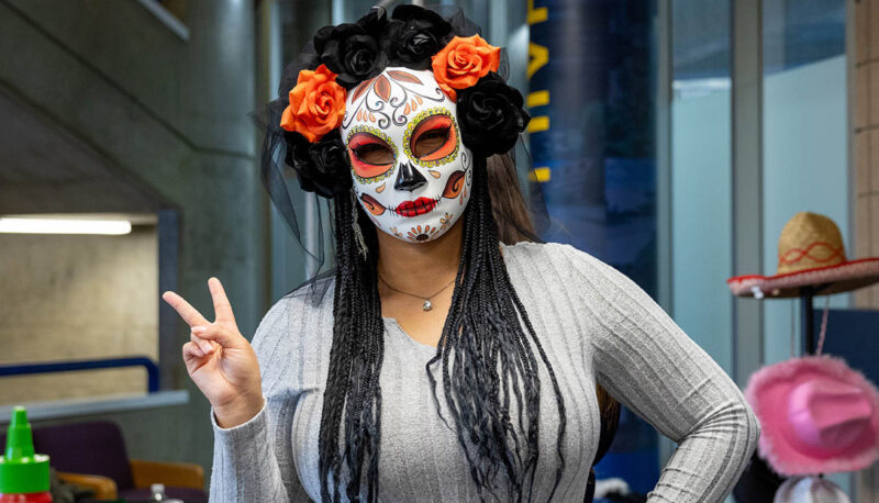 A student wearing a sugar skull mask.