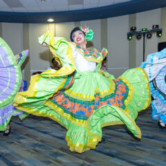 Folklorico dancers twirling in the Happenings Room.