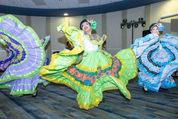 Folklorico dancers twirling in the Happenings Room.