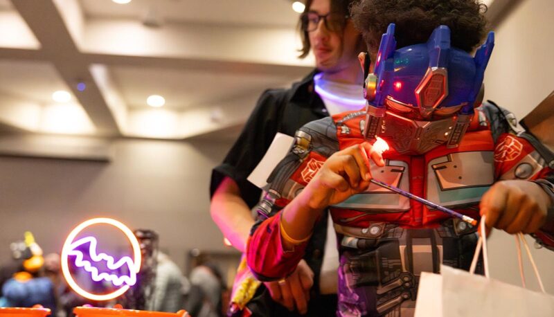 A small child in an Optimus Prime costume trick or treating