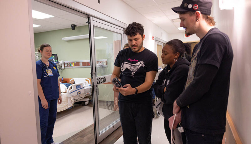 A cameraman showing footage in the nursing simulation lab