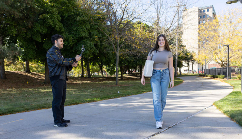 A student being filmed outside the William S. White Building