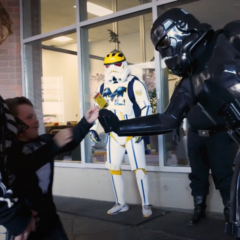 A crew of Star Wars stormtroopers giving out treats to a child attending Inclusive Halloween