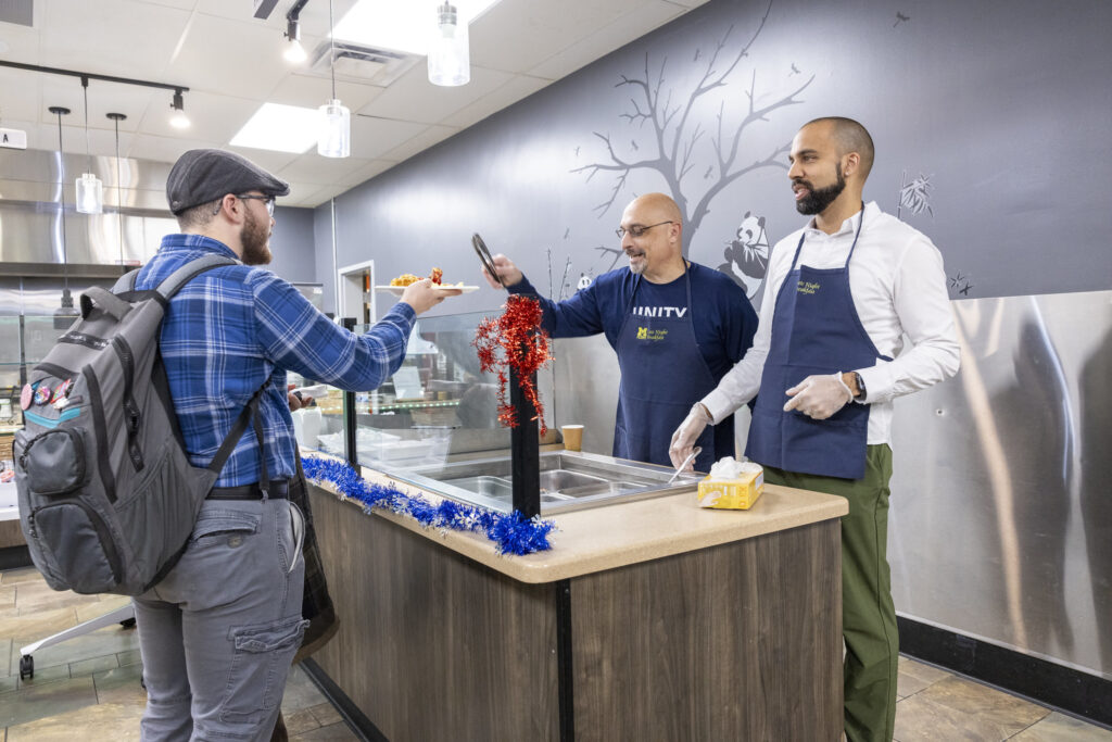 A late-night breakfast tradition features staff serving students. Pictured (left to right): Christopher "Dr. G" Giordano, PhD, Vice Chancellor for Student Affairs, and David "Dr. Luke" Luke, PhD, Chief Diversity Officer.