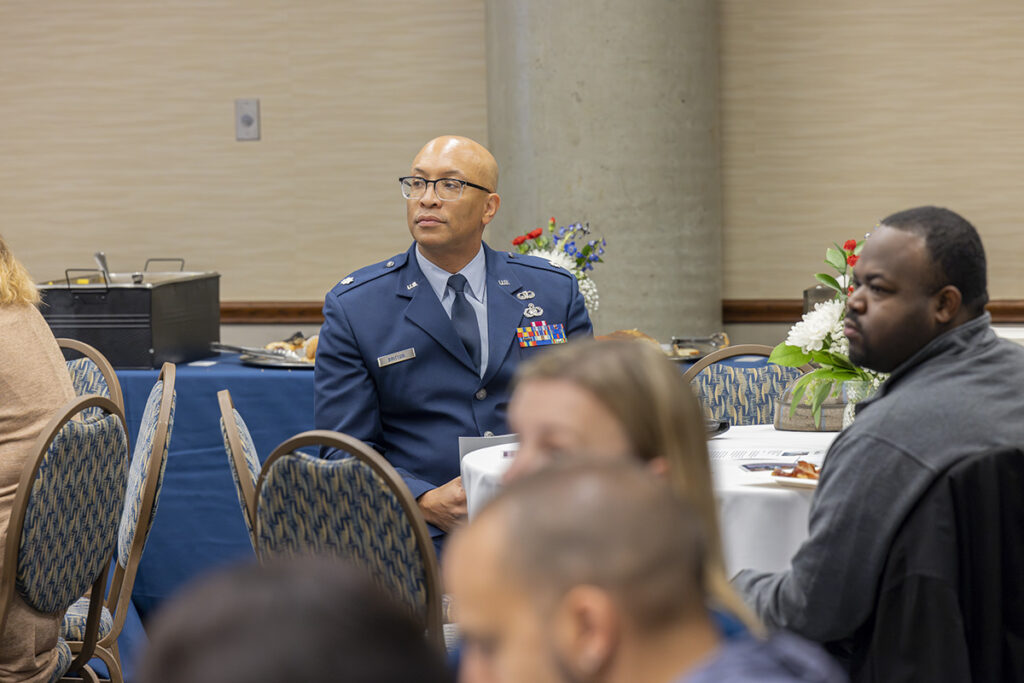 Britton seated in the crowd wearing an Air Force dress uniform