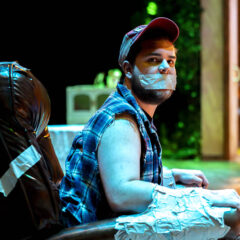 A student actor on stage duct taped to a chair