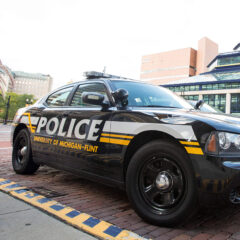 A UM-Flint DPS vehicle parked in front of the UM-Flint Pavilion