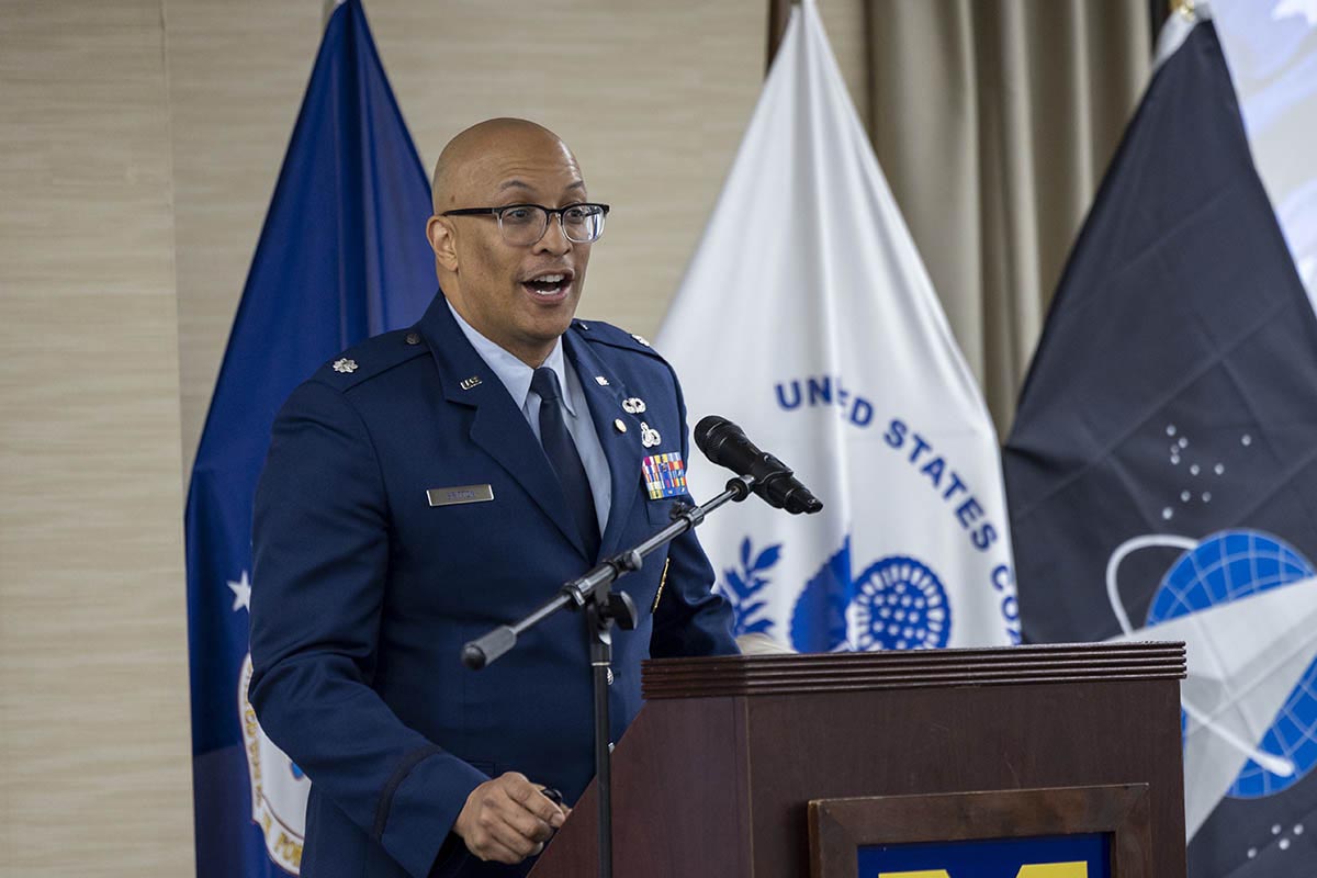 A man in an Air Force dress uniform speaking at a podium.