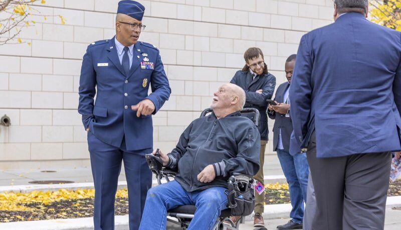 A man in an Air Force dress uniform speaking with event attendees