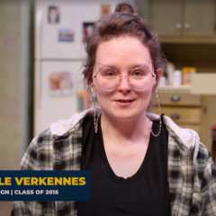 A screenshot of Danielle Verkennes sitting on stage talking to the camera.