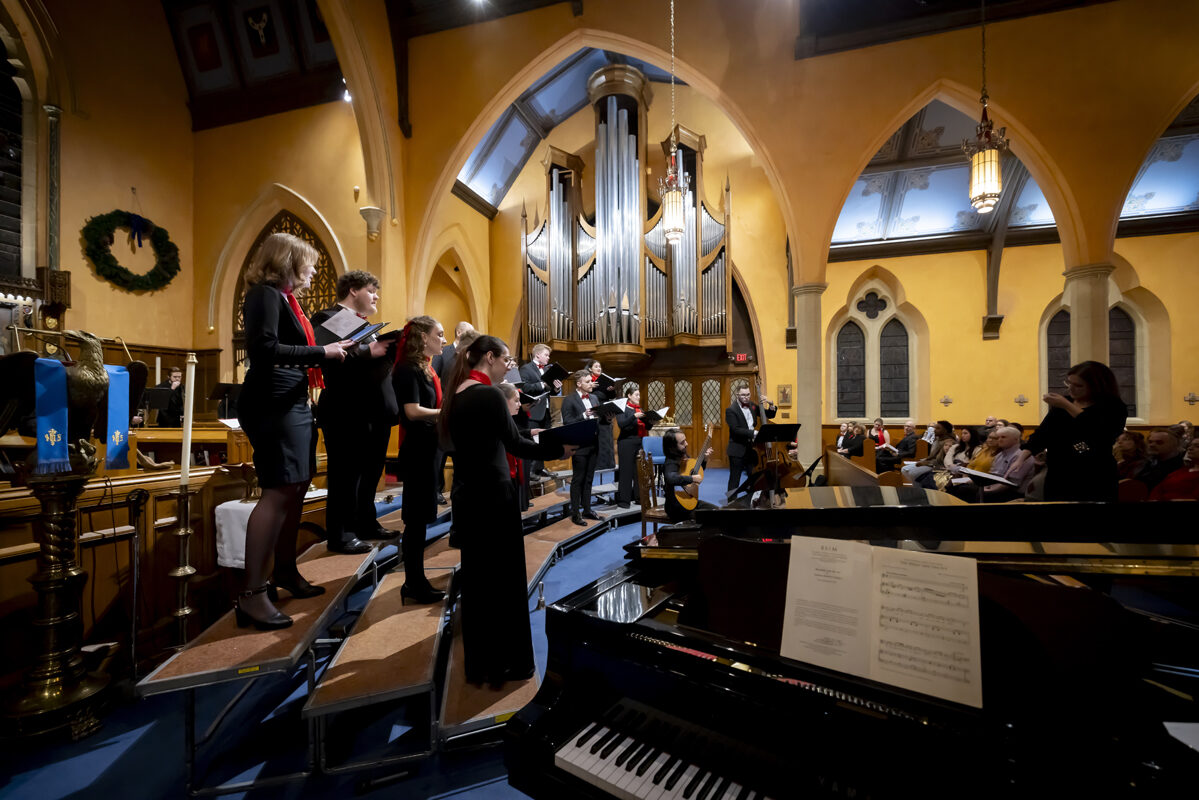 A choir performs in a brightly lit church.