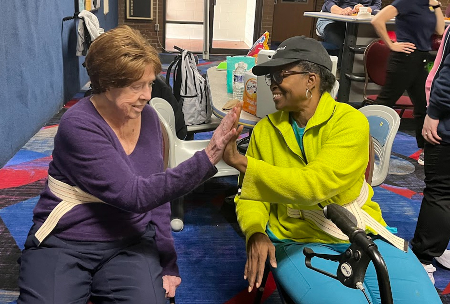 Two OT patients high fiving. 