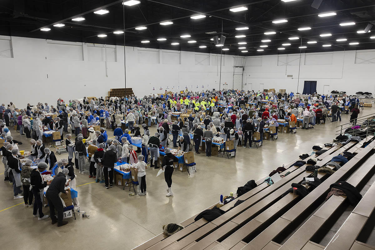 A wide shot of a crowd UM-Flint volunteers packing food