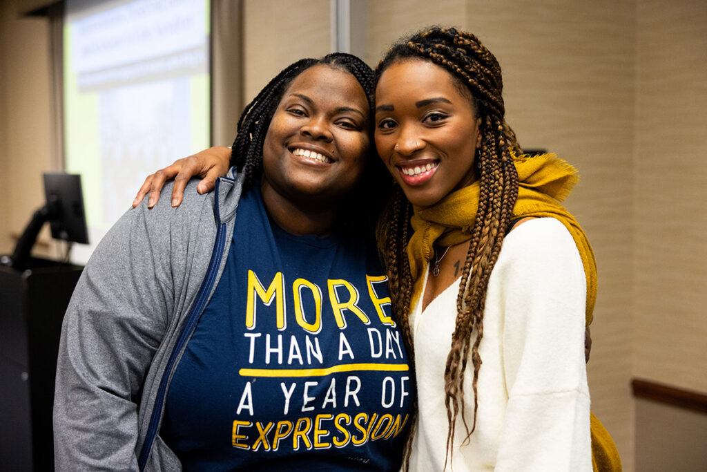 Two UM-Flint staff members smiling for a photo. 