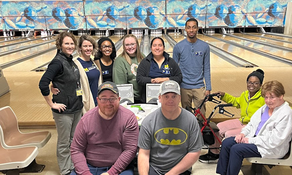 A group of UM-Flint students/faculty and community patients at the bowling alley. 