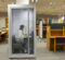 A student working on her laptop inside a quiet study pod in the library.