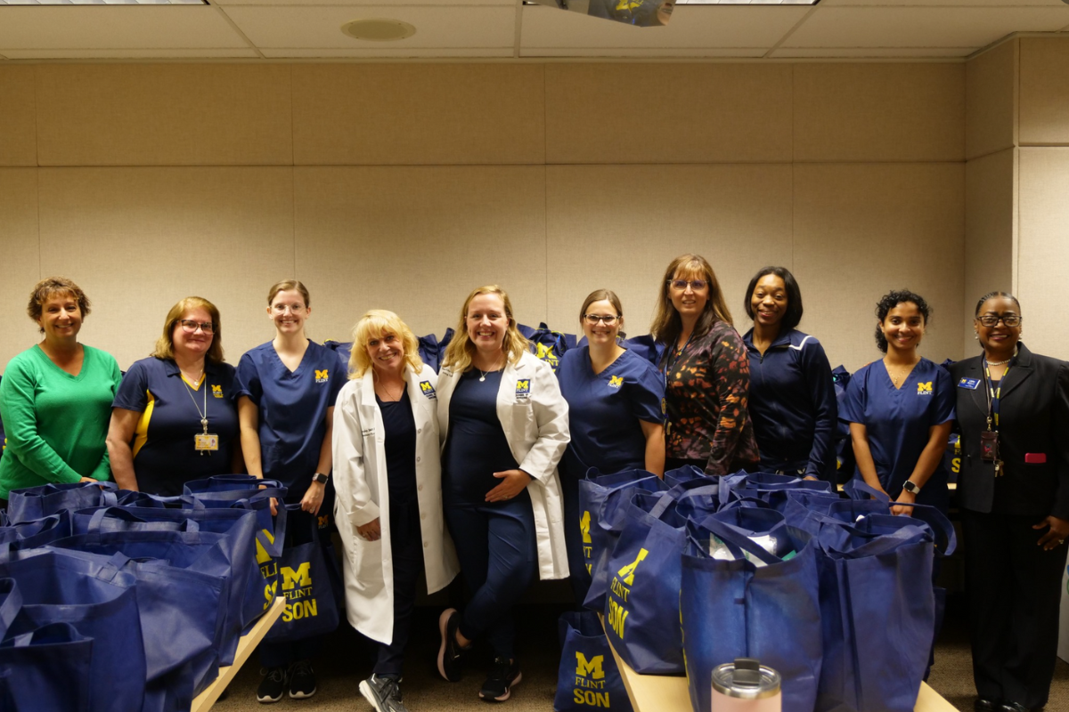 University of Michigan-Flint nursing students and faculty prepared packages for new babies and families as part of the NurtureFirst initiative. Pictured from left to right are Denise Campbell, Megan Keiser, Michelle Smith, Maureen Murphy, Elizabeth Fulks, Jenna Depollo, Lisa Tedrow, Asia Suggs, Imani Hasty, Libby Bell