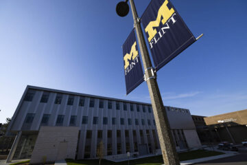 An exterior view of the MSB Expansion with a UM-Flint banner in the foreground