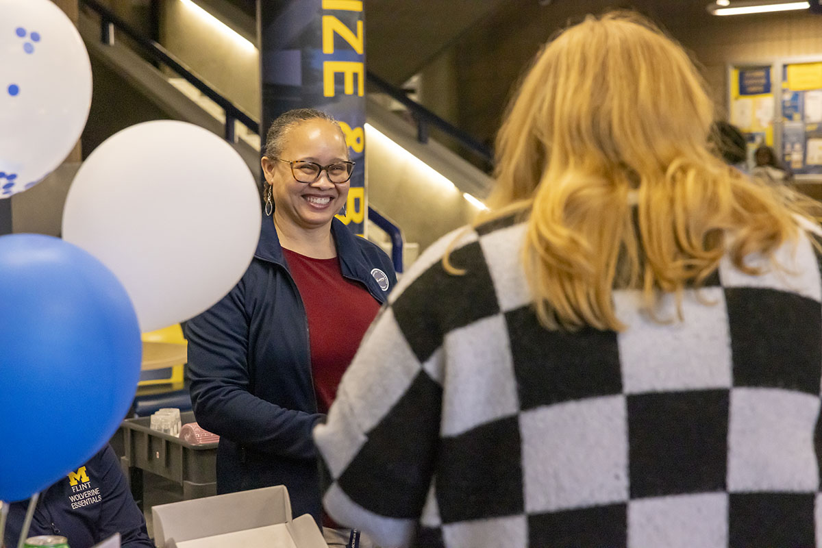 A staff member smiling in the University Center.