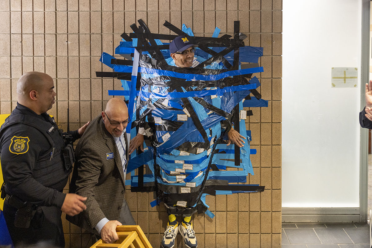 Chancellor Alexander fully duct taped to the wall.