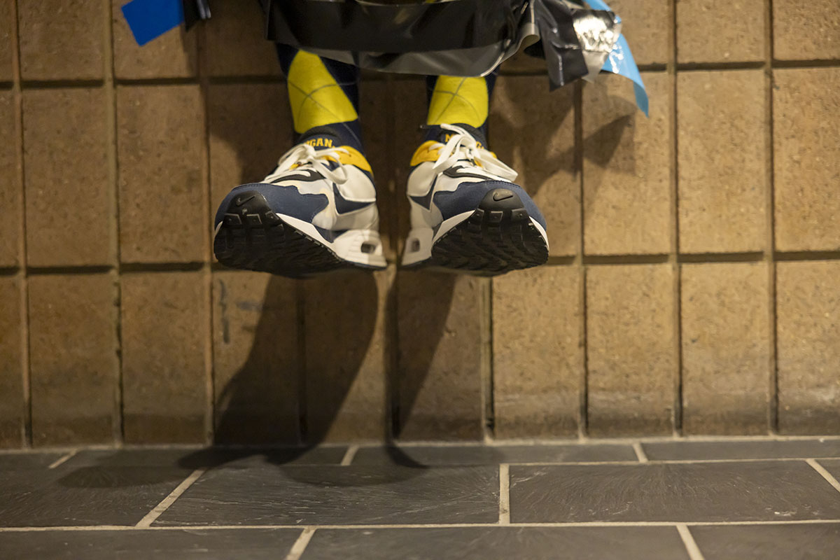 A detail shot of Chancellor Alexander's shoes hovering above the ground as he is duct taped.