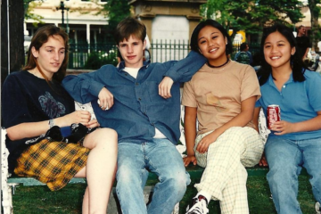 A group of young people sitting together on a couch