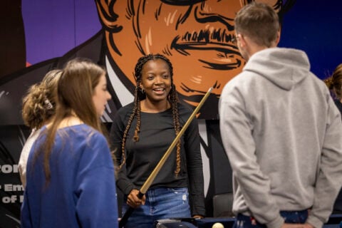 Students enjoy a game of pool during the fall 2024 Late Night Breakfast.