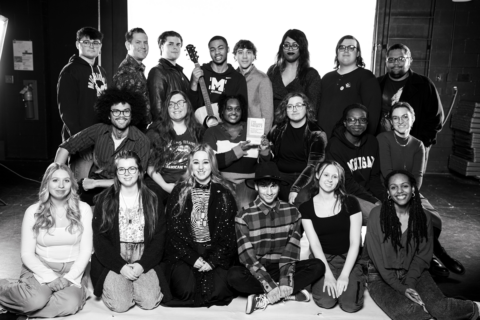 A black and white photo of the cast of "The Laramie Project" posing for the camera