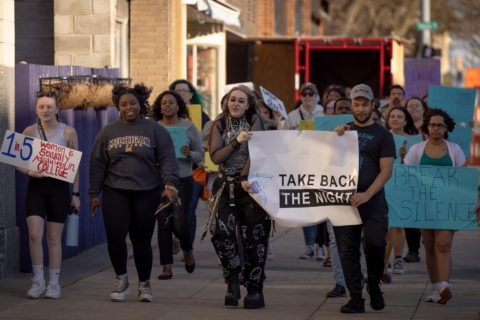 Students march together with signs at Take Back the Night in 2023.
