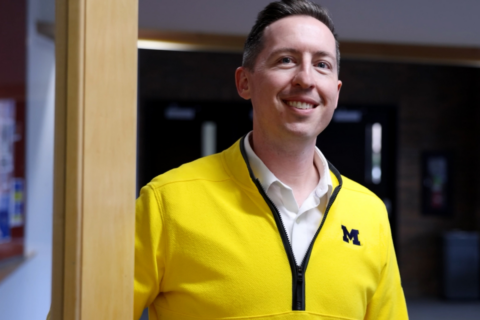 Nick Gaspar in a yellow Michigan sweater