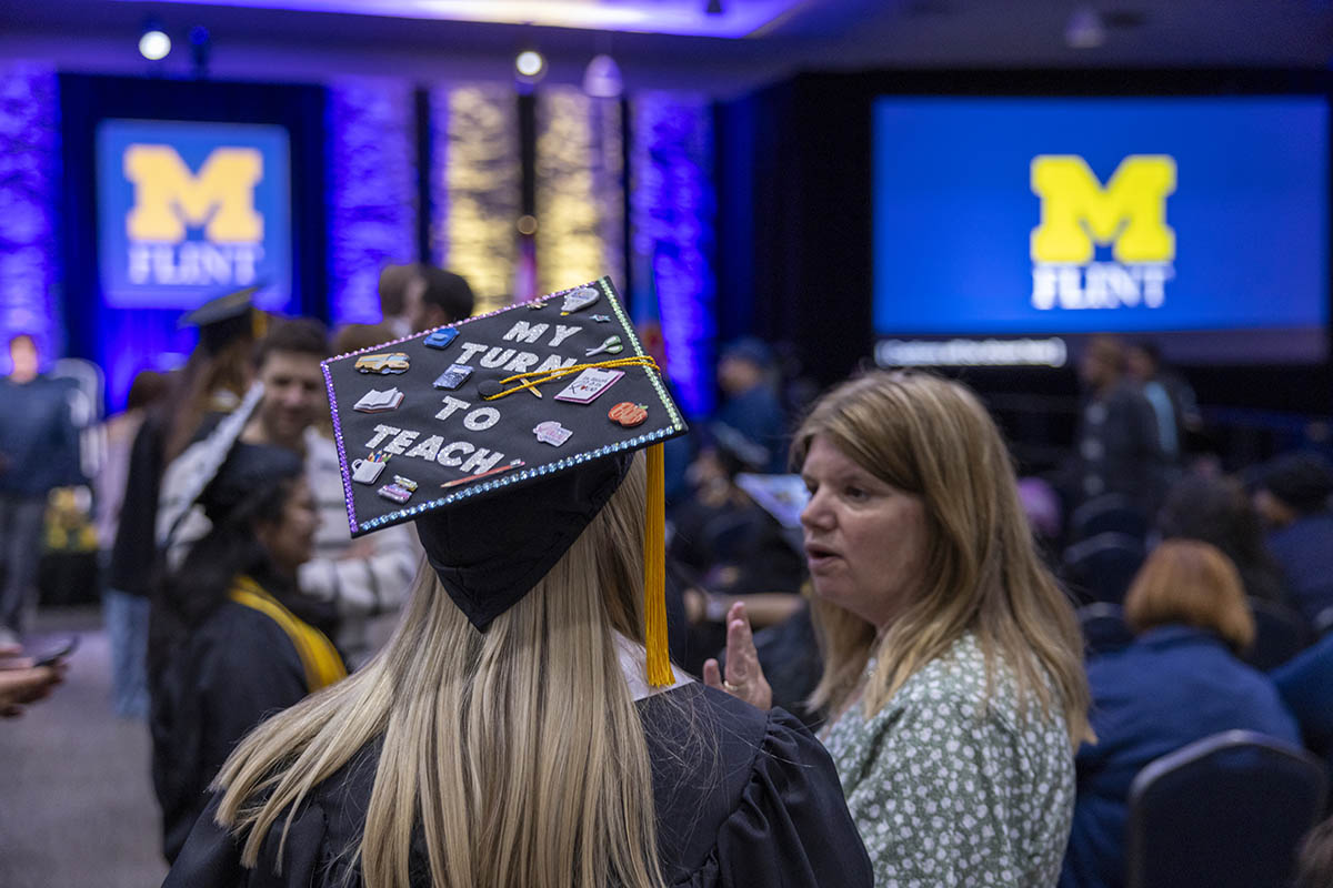 A decorated graduation cap that says "My turn to teach."