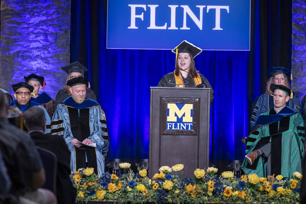 Kennedy Lyons speaking on the Commencement stage.