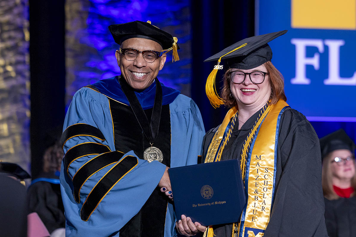 Diane Tupper receiving her diploma cover from Chancellor Laurence Alexander.