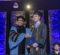 Chancellor Laurence Alexander shakes hands with a School of Nursing student on stage with the photo subjects in graduation regalia.