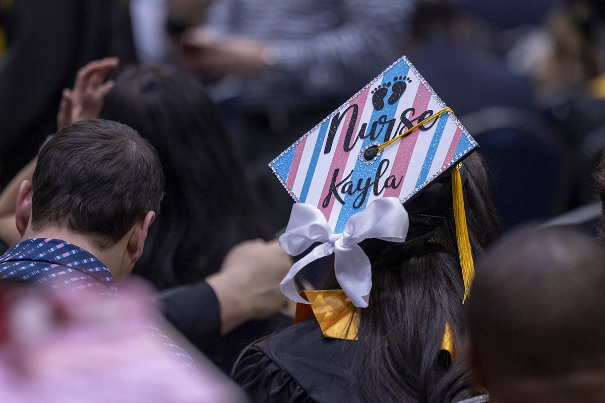 A decorated graduation cap that says "Nurse Kayla."