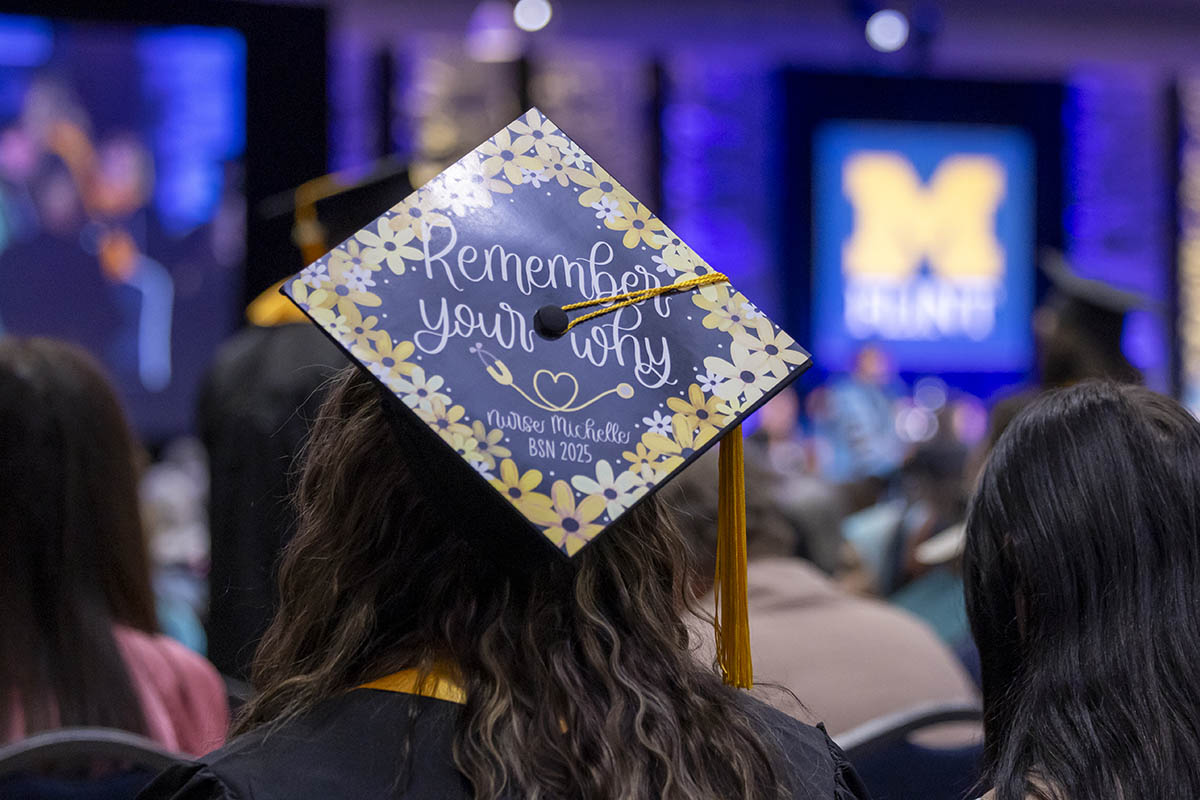 A decorated graduation cap that says "Remember your why."