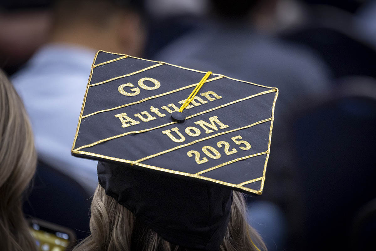 A decorated graduation cap that says "Go Autumn UoM 2025"