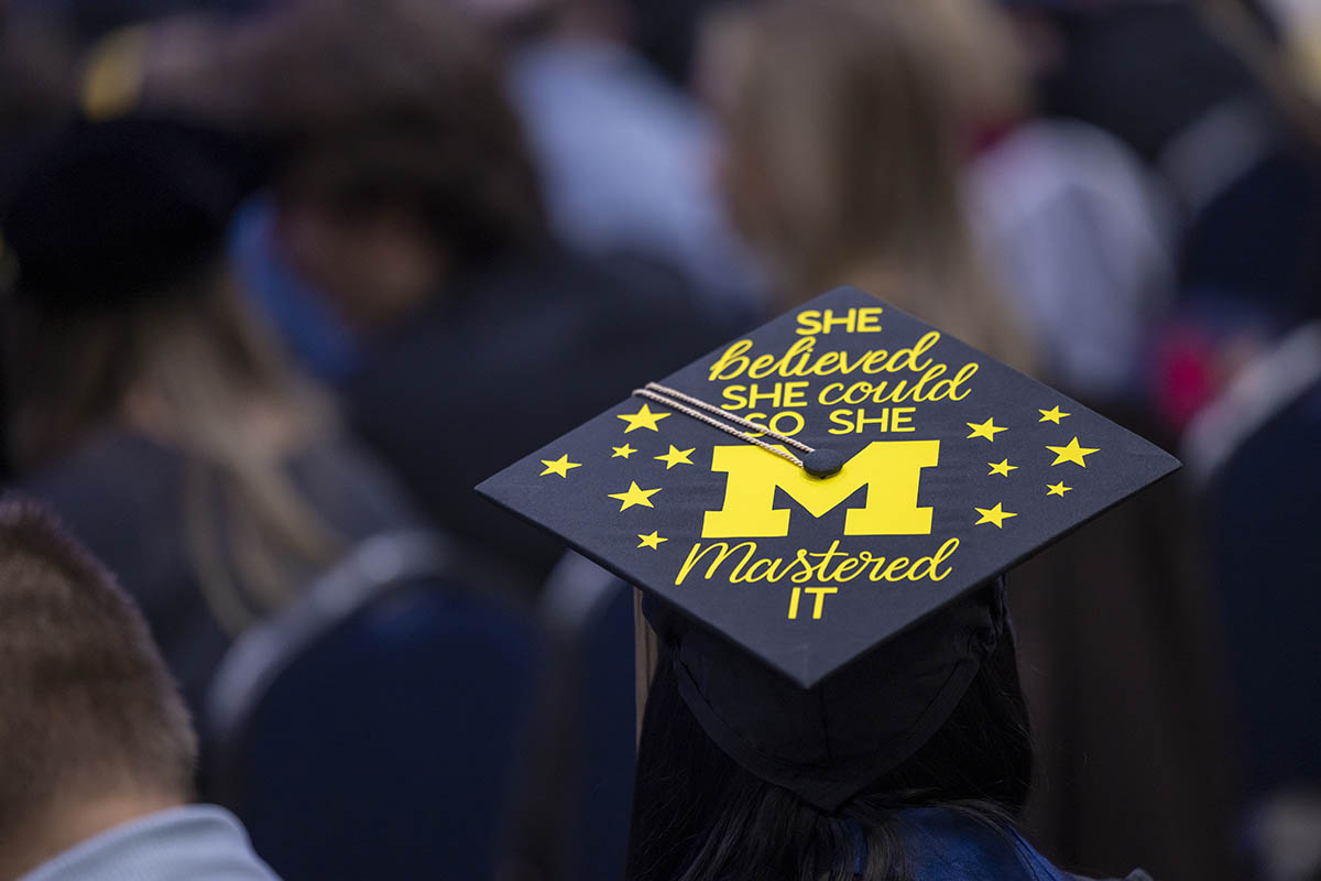 A decorated graduation cap that says "She believed she could so she mastered it."