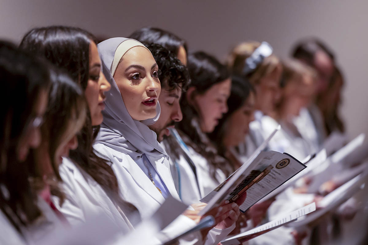 Students reciting an oath in the crowd.