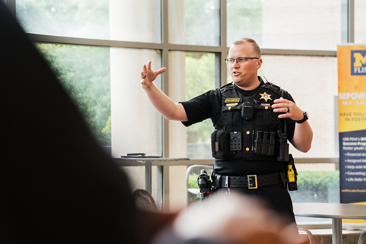 A close up shot of a male police officer speaking.