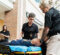 Police officers treating the mock patient on the stretcher.