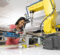A student works on a robotic arm.