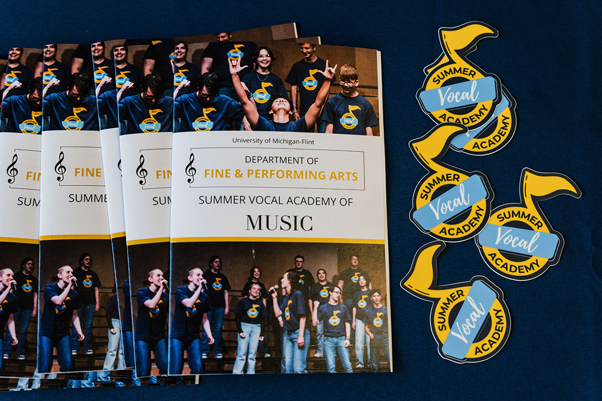 Summer Vocal Academy of Music paper programs arrayed on a table with a blue tablecloth.